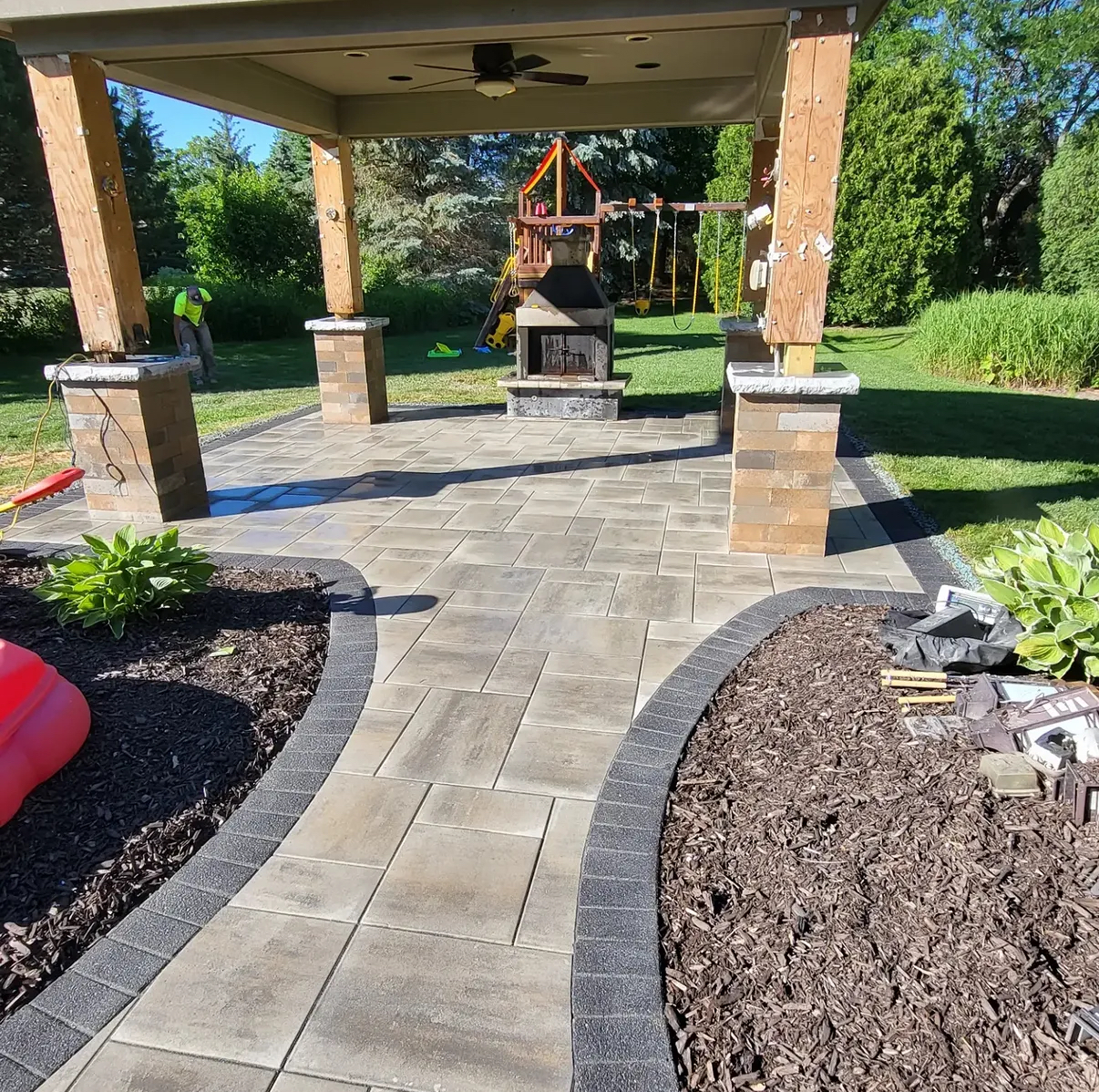 Custom covered patio fireplace by Roman Brothers Landscaping — Southeast Wisconsin